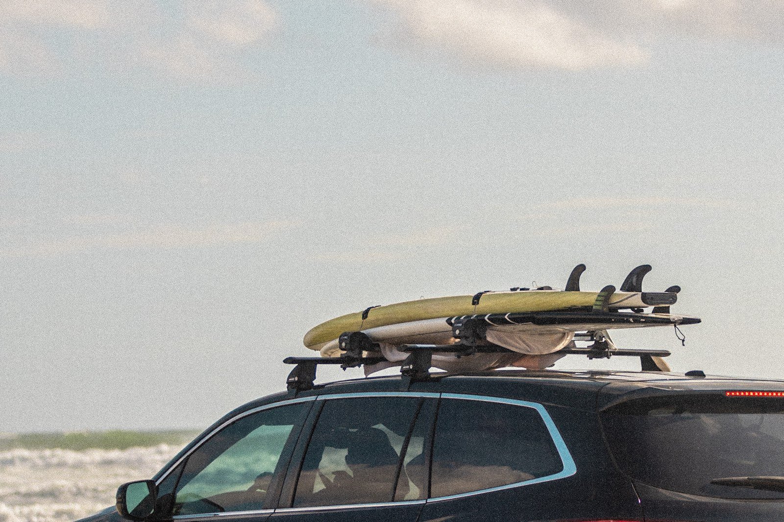 Surfboards racked on a car roof at New Smyrna Beach